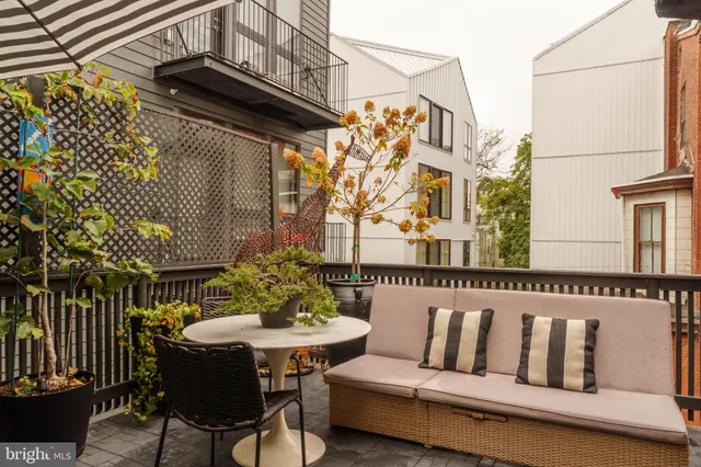 a balcony with table and chairs
