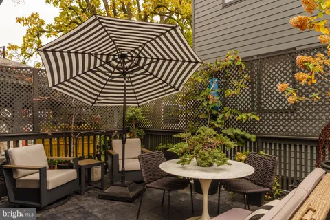 a balcony with table and chairs
