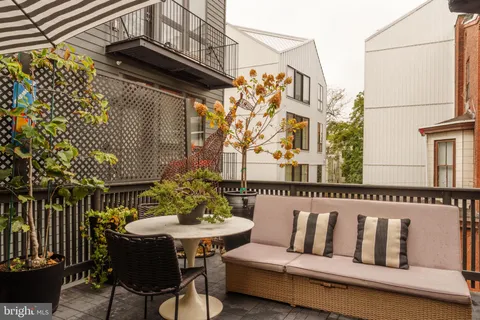 a view of a bedroom with furniture and window