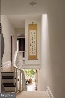 a bedroom with a large bed and a flat tv screen on dresser