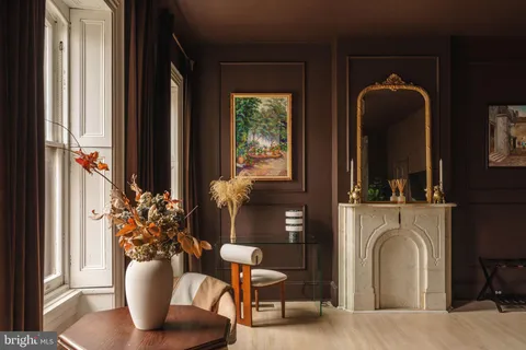 a living room with furniture cabinets and a window