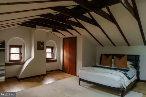 a bedroom with a bed and a mirror