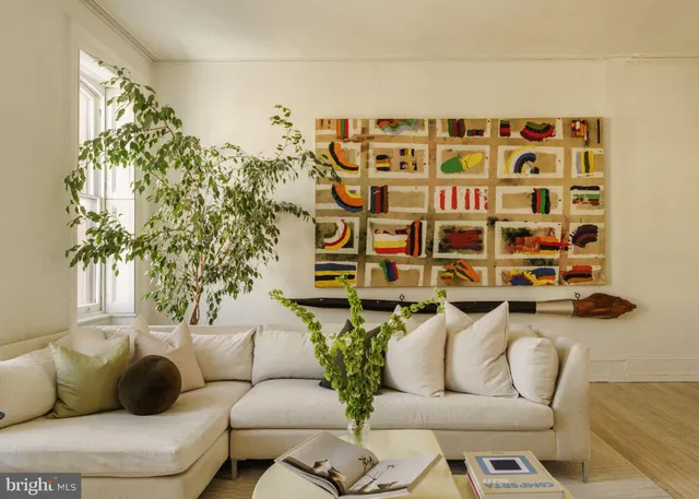 a living room with furniture and a potted plant