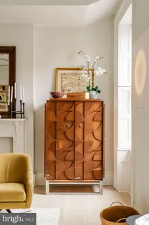 a living room with a couch and a potted plant