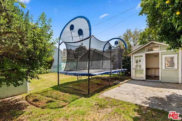 a view of a house with backyard and sitting area