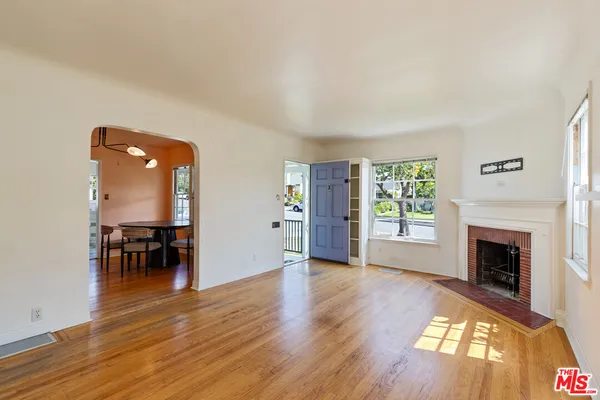 a view of empty room with furniture and fireplace
