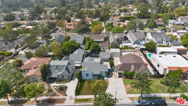 an aerial view of residential houses with green space