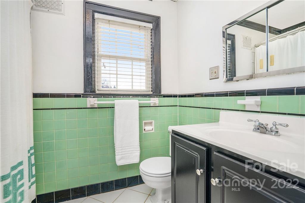 1520 Paddock Circle Charlotte, NC 28209 - Photo 26 of 39 a bathroom with a sink a toilet and mirror
