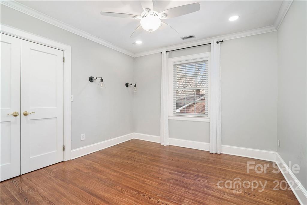 1520 Paddock Circle Charlotte, NC 28209 - Photo 28 of 39 a view of an empty room with wooden floor and a window