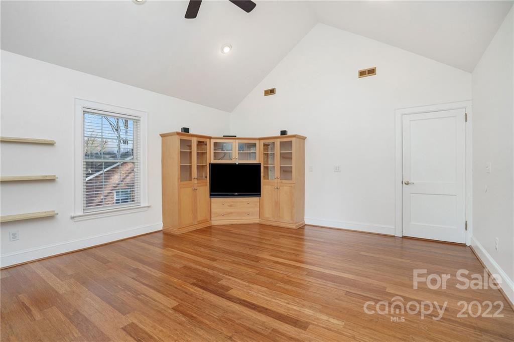 1520 Paddock Circle Charlotte, NC 28209 - Photo 32 of 39 a view of an empty room with wooden floor and a window