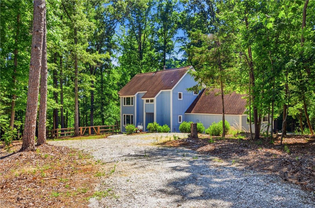 1298 Carradine Road Seneca, SC 29678 - Photo 2 of 43 A tranquil, tree-lined setting envelops this welcoming property, offering peaceful seclusion and natural beauty.