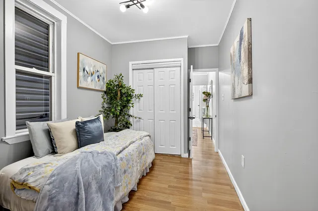 a spacious bedroom with a bed and a wooden floor