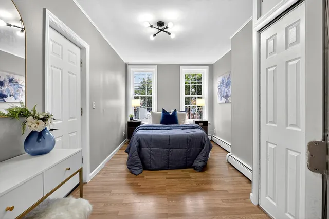 a living room with furniture potted plant and windows