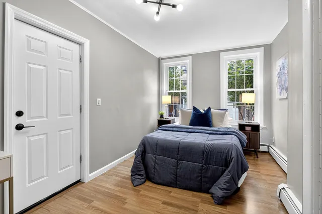 a bedroom with a bed and window