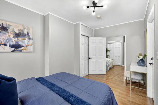 a bedroom with a bed and a painting on the wall