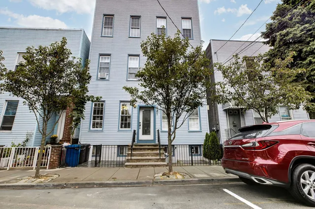 a view of a car is parked in front of a building