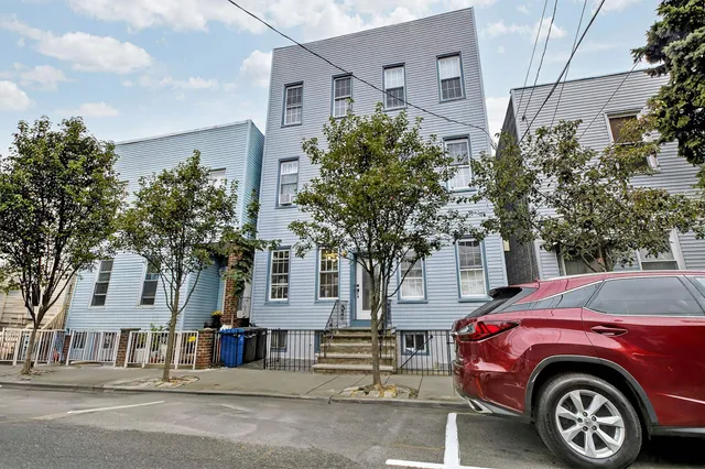 a front view of a house with a garden