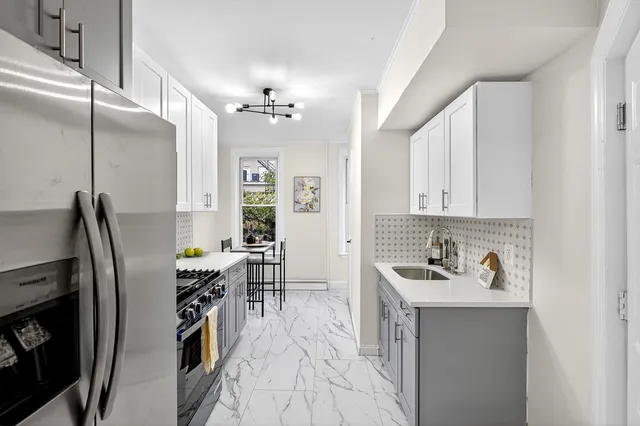 a kitchen with a sink appliances and cabinets