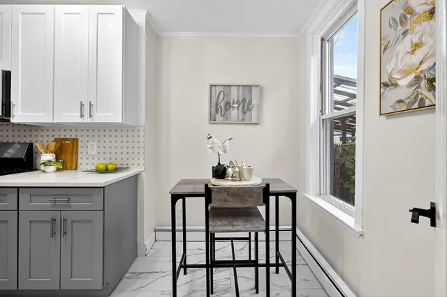 a dining room with a table and chairs