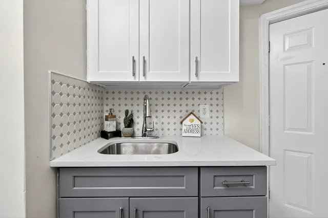 a kitchen with a sink and cabinets