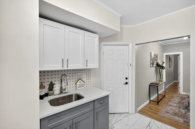 a kitchen with a sink and refrigerator