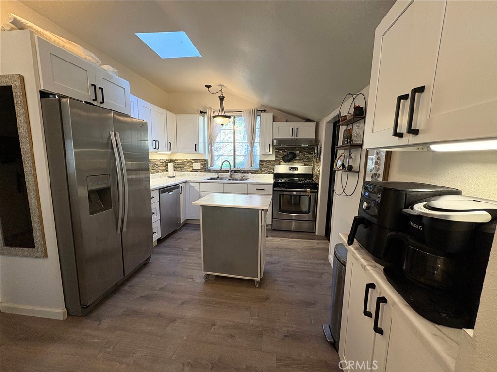 36750 Hilltop Road Yucaipa, CA 92399 - Photo 11 of 27 a kitchen with stainless steel appliances granite countertop a stove refrigerator and a sink