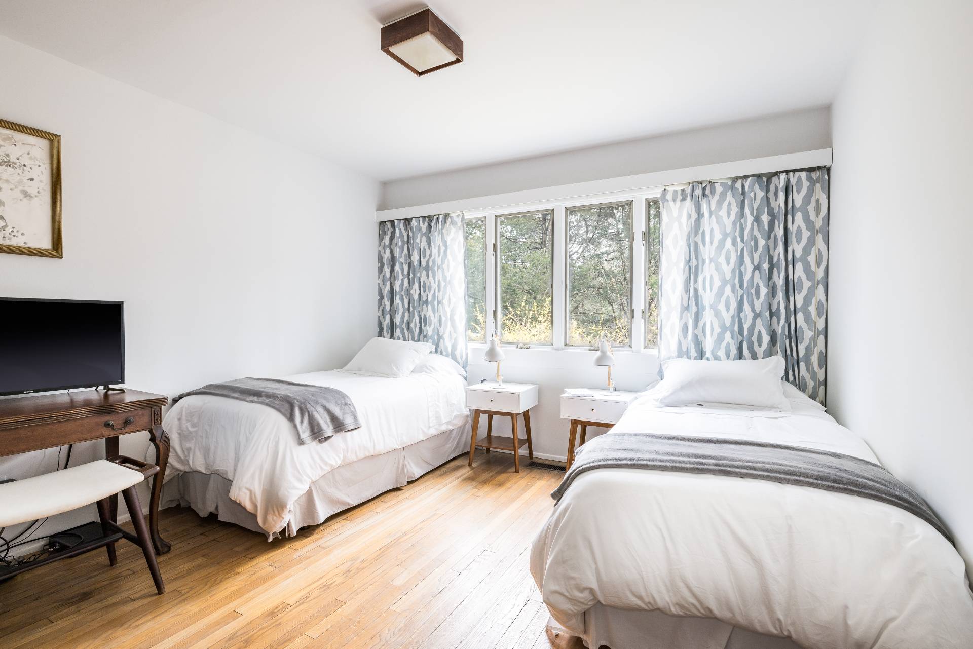 291 Three Mile Harbor Road East Hampton, NY 11937 - Photo 13 of 17 a bedroom with two beds and a large window