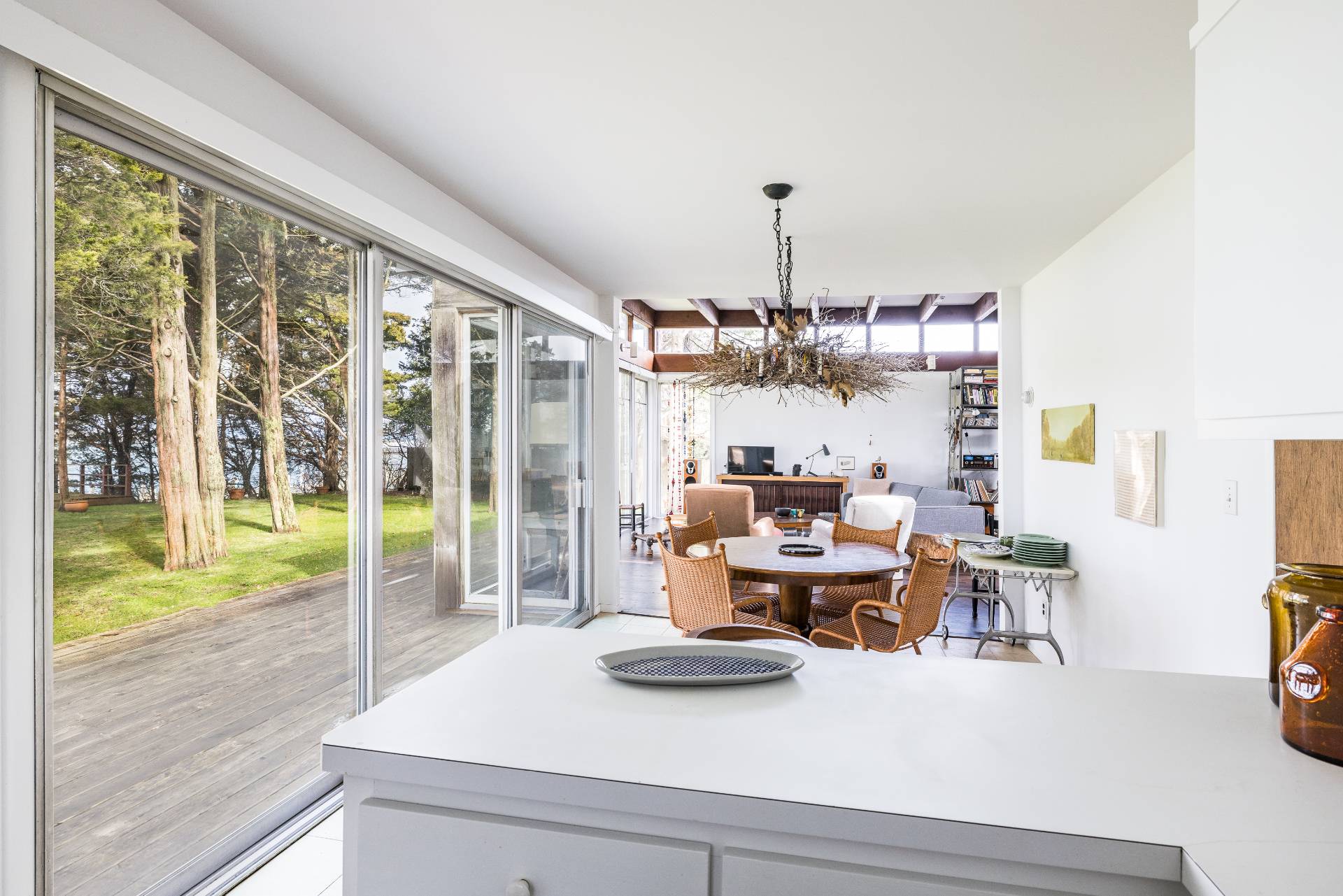 291 Three Mile Harbor Road East Hampton, NY 11937 - Photo 9 of 17 a view of a dining room with furniture a chandelier and wooden floor