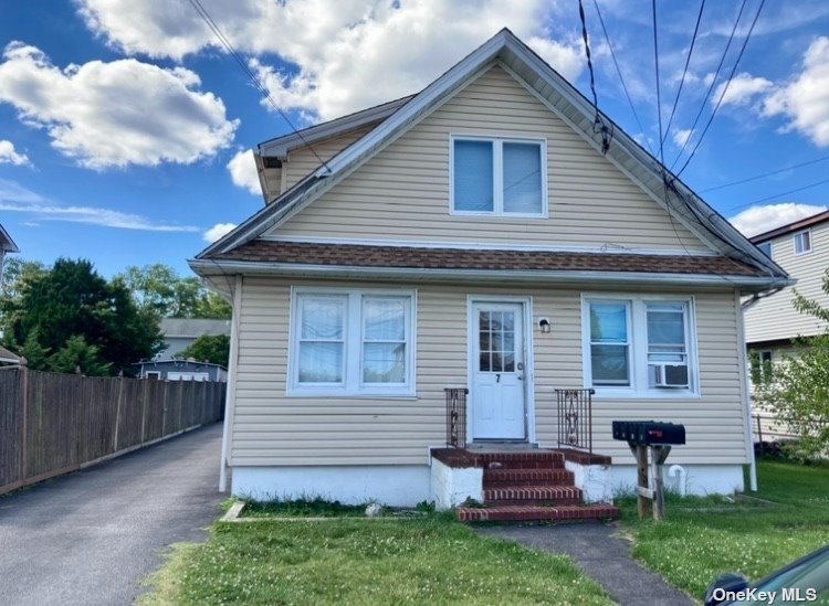 7 South Atlantic Street Bay Shore, NY 11706 - Photo 1 of 1 a front view of a house with garden