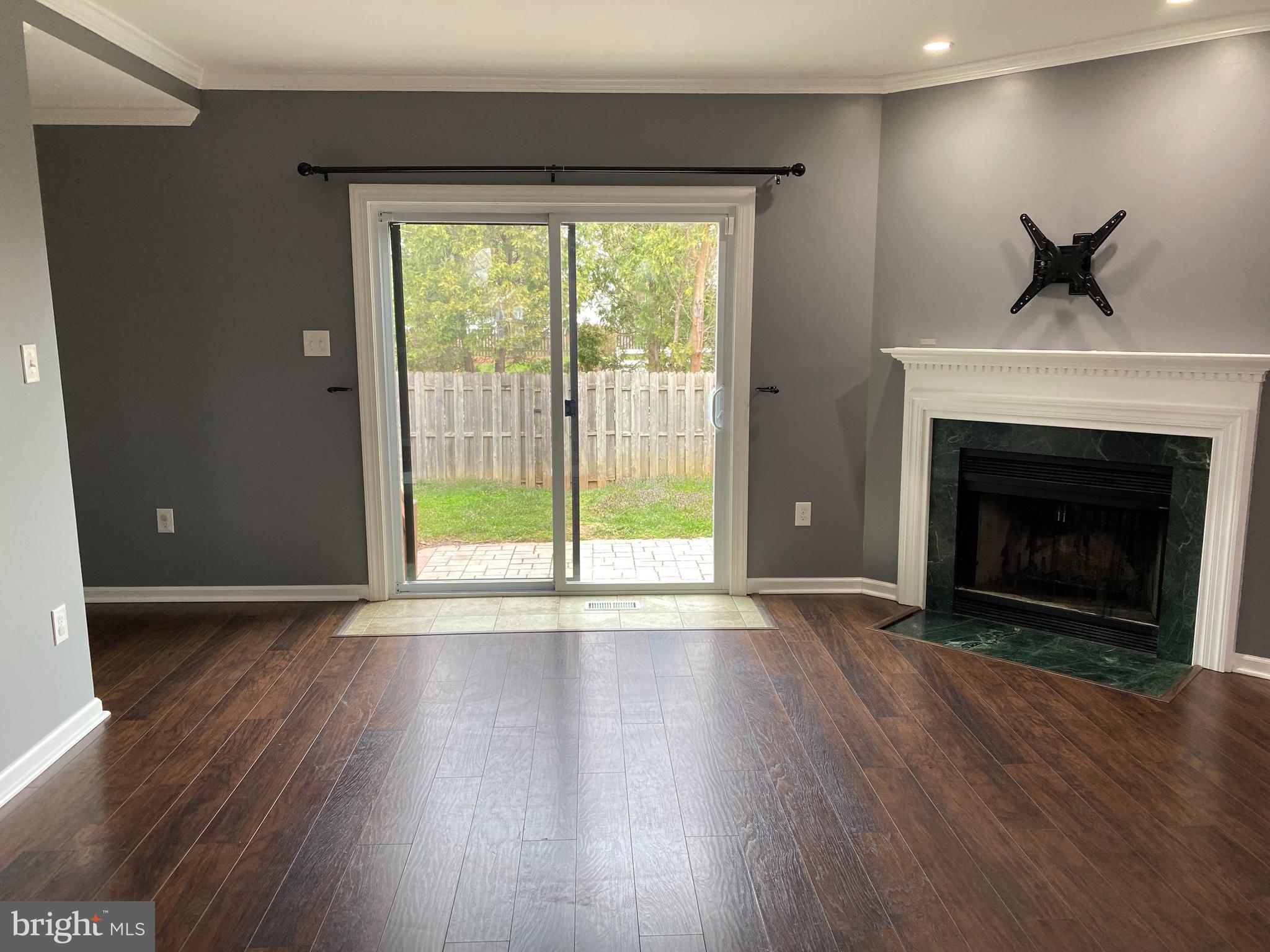 4 Victoria Square Frederick, MD 21702 - Photo 13 of 38 a view of an empty room with wooden floor and a window