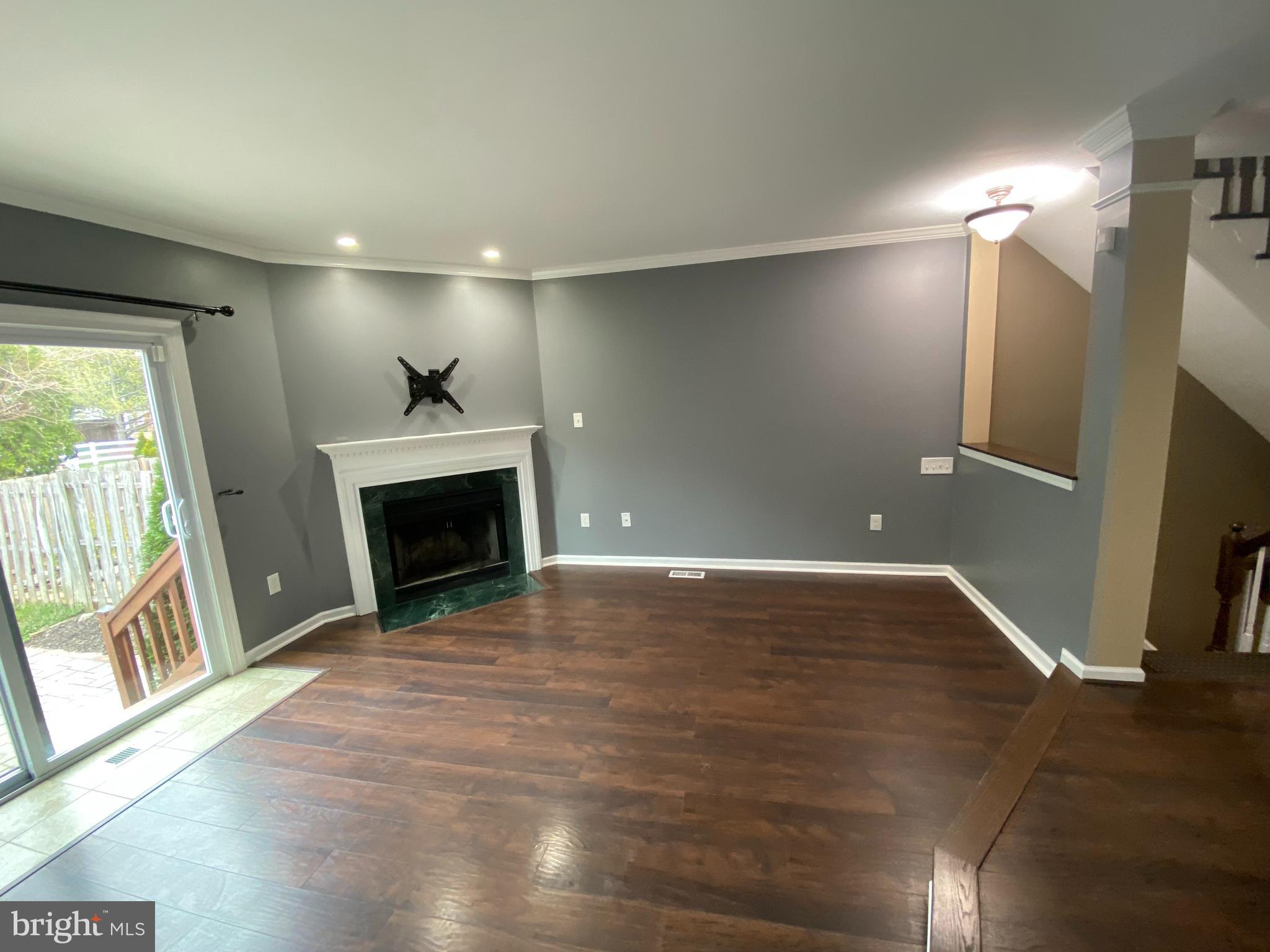 4 Victoria Square Frederick, MD 21702 - Photo 14 of 38 a view of empty room with wooden floor and fireplace
