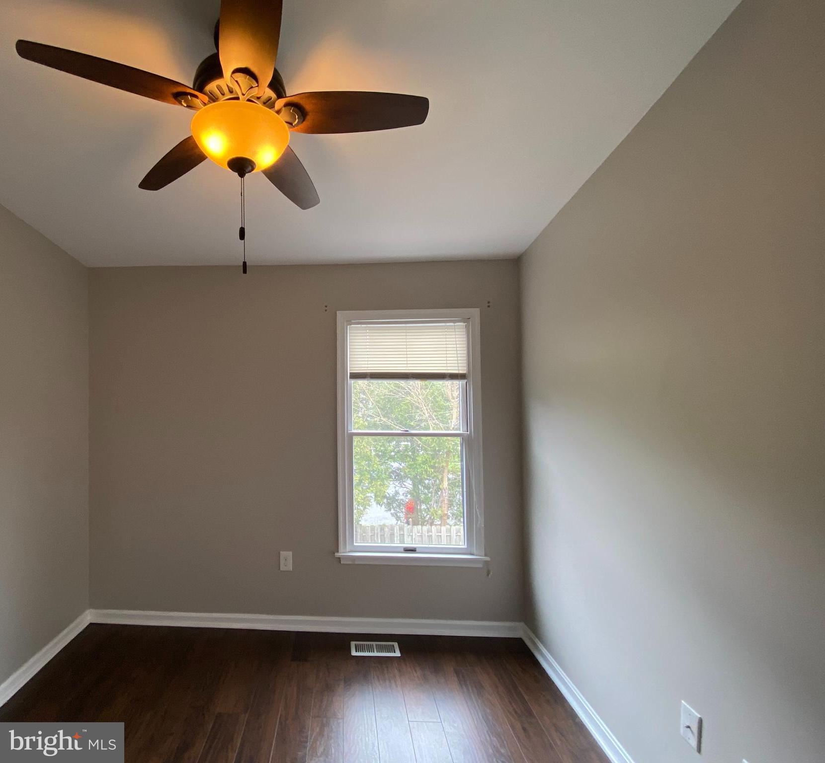 4 Victoria Square Frederick, MD 21702 - Photo 21 of 38 an empty room with wooden floor fan and windows