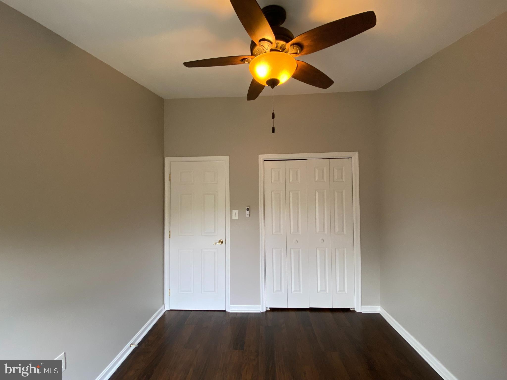 4 Victoria Square Frederick, MD 21702 - Photo 22 of 38 an empty room with a fan and wooden floor