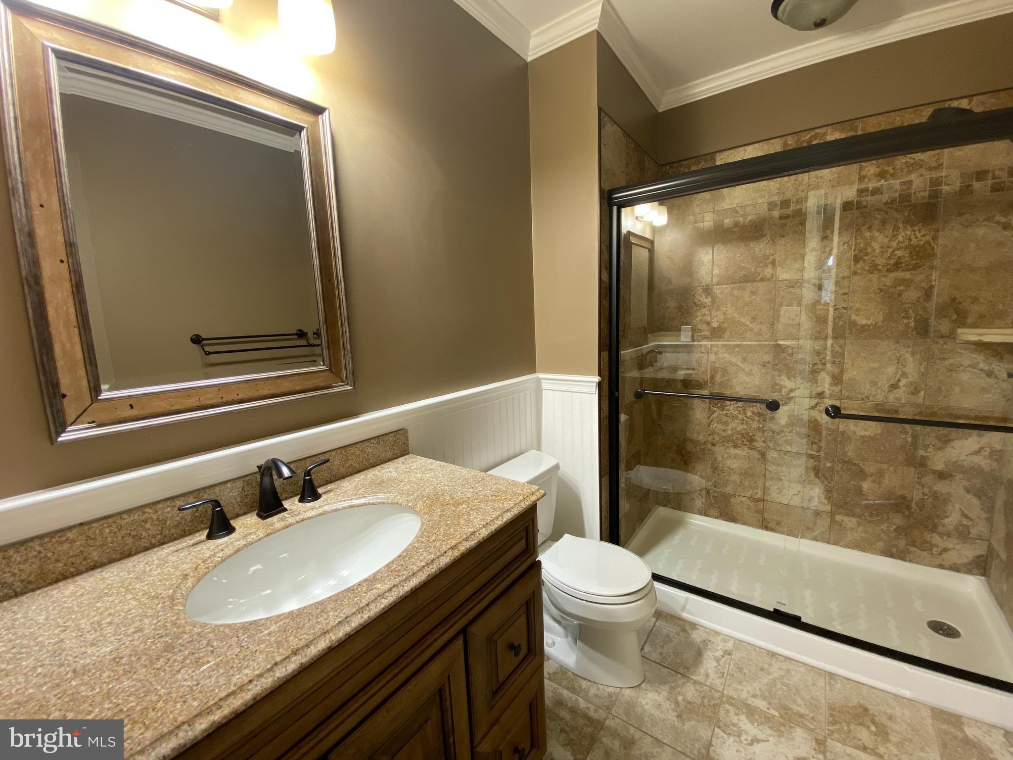 4 Victoria Square Frederick, MD 21702 - Photo 26 of 38 a bathroom with a granite countertop sink toilet and shower
