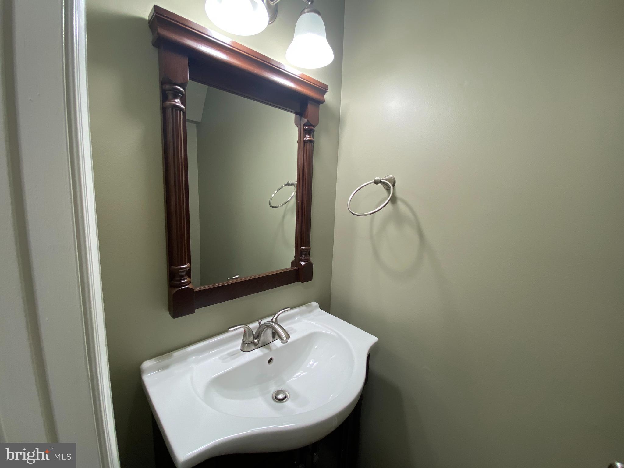4 Victoria Square Frederick, MD 21702 - Photo 28 of 38 a bathroom with a sink and a mirror