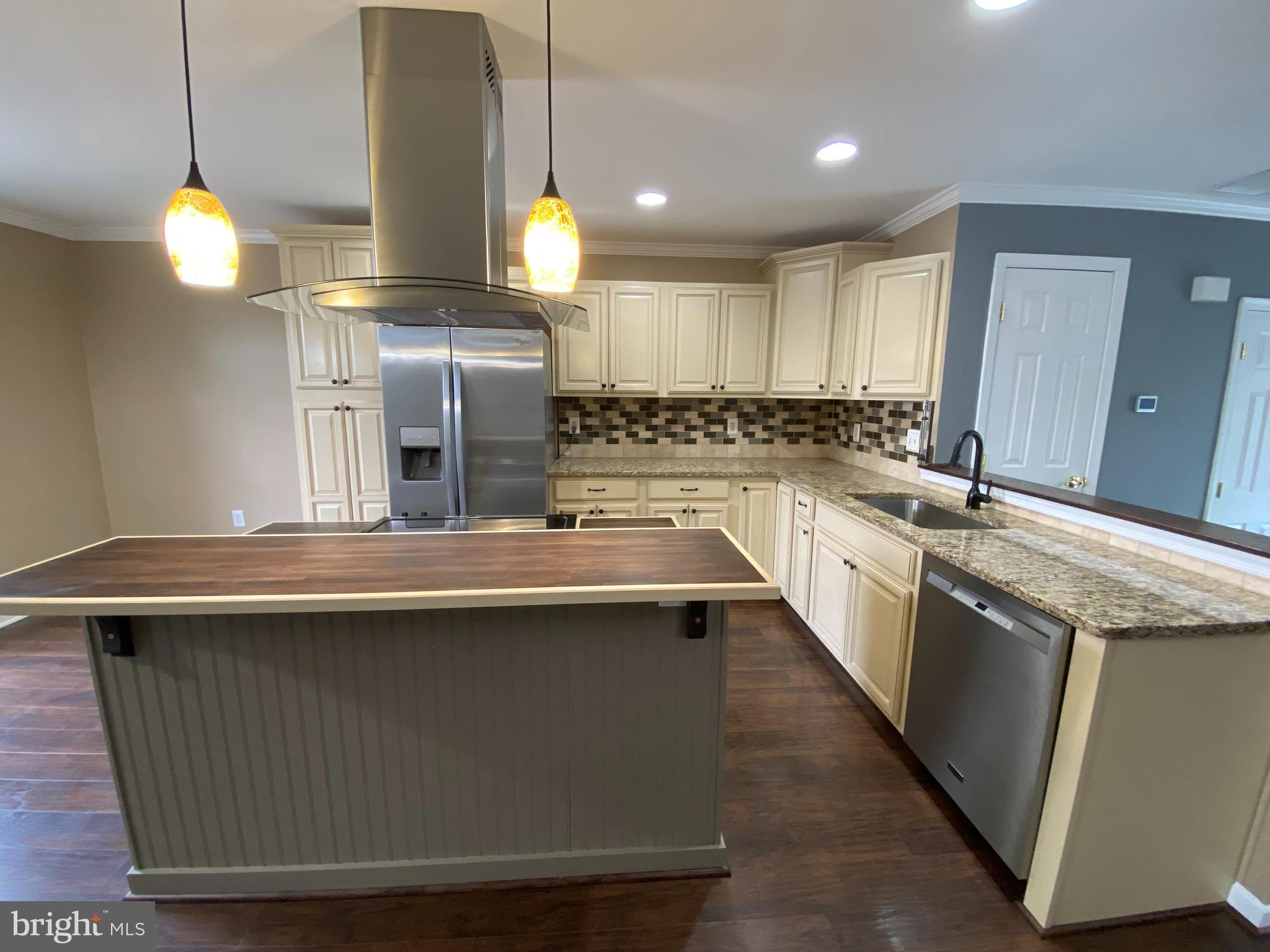 4 Victoria Square Frederick, MD 21702 - Photo 5 of 38 a kitchen with stainless steel appliances granite countertop a sink a stove and a wooden floors
