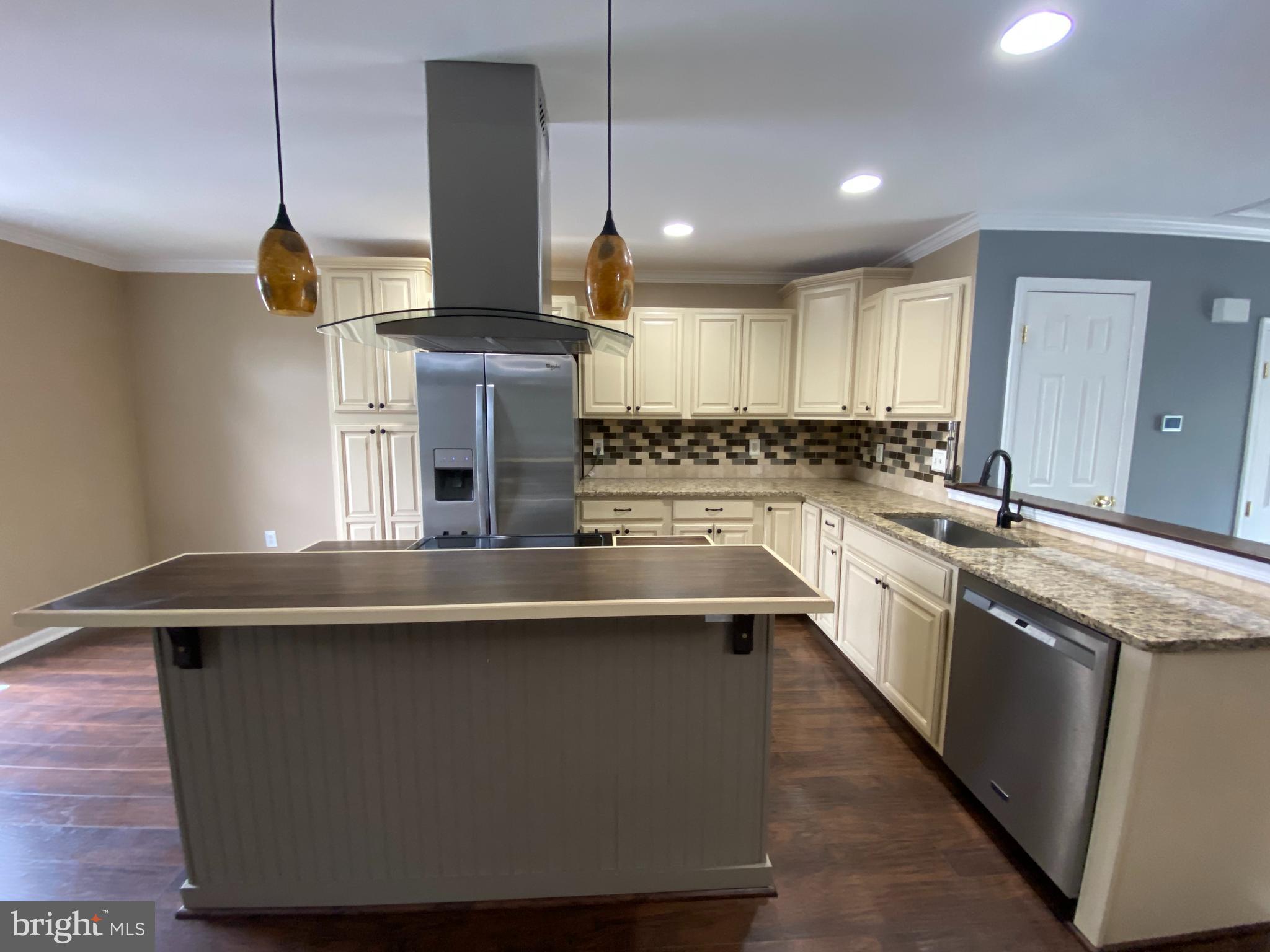 4 Victoria Square Frederick, MD 21702 - Photo 6 of 38 a kitchen with stainless steel appliances granite countertop a sink a stove and a wooden floors
