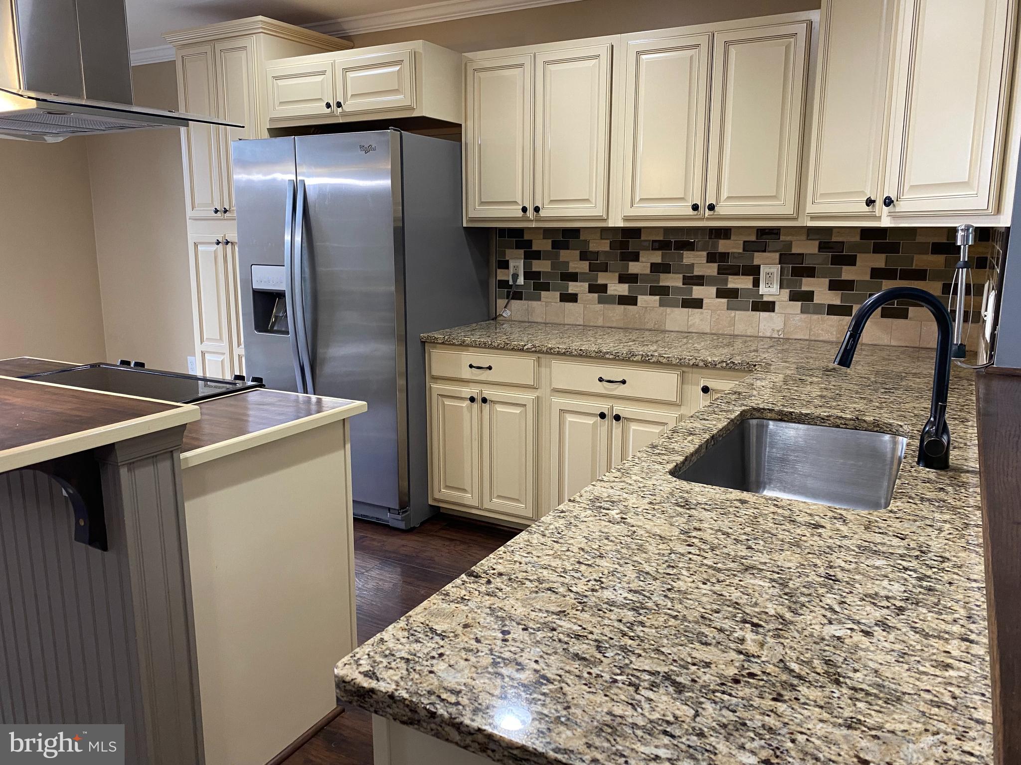 4 Victoria Square Frederick, MD 21702 - Photo 8 of 38 a kitchen with stainless steel appliances granite countertop a sink stove and refrigerator