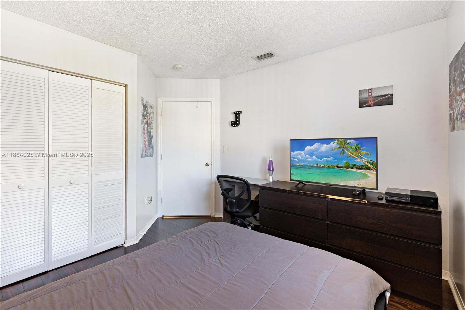 13402 Southwest 153rd Street, Unit 1905 Miami, FL 33177 - Photo 11 of 21 a living room with furniture and a flat screen tv