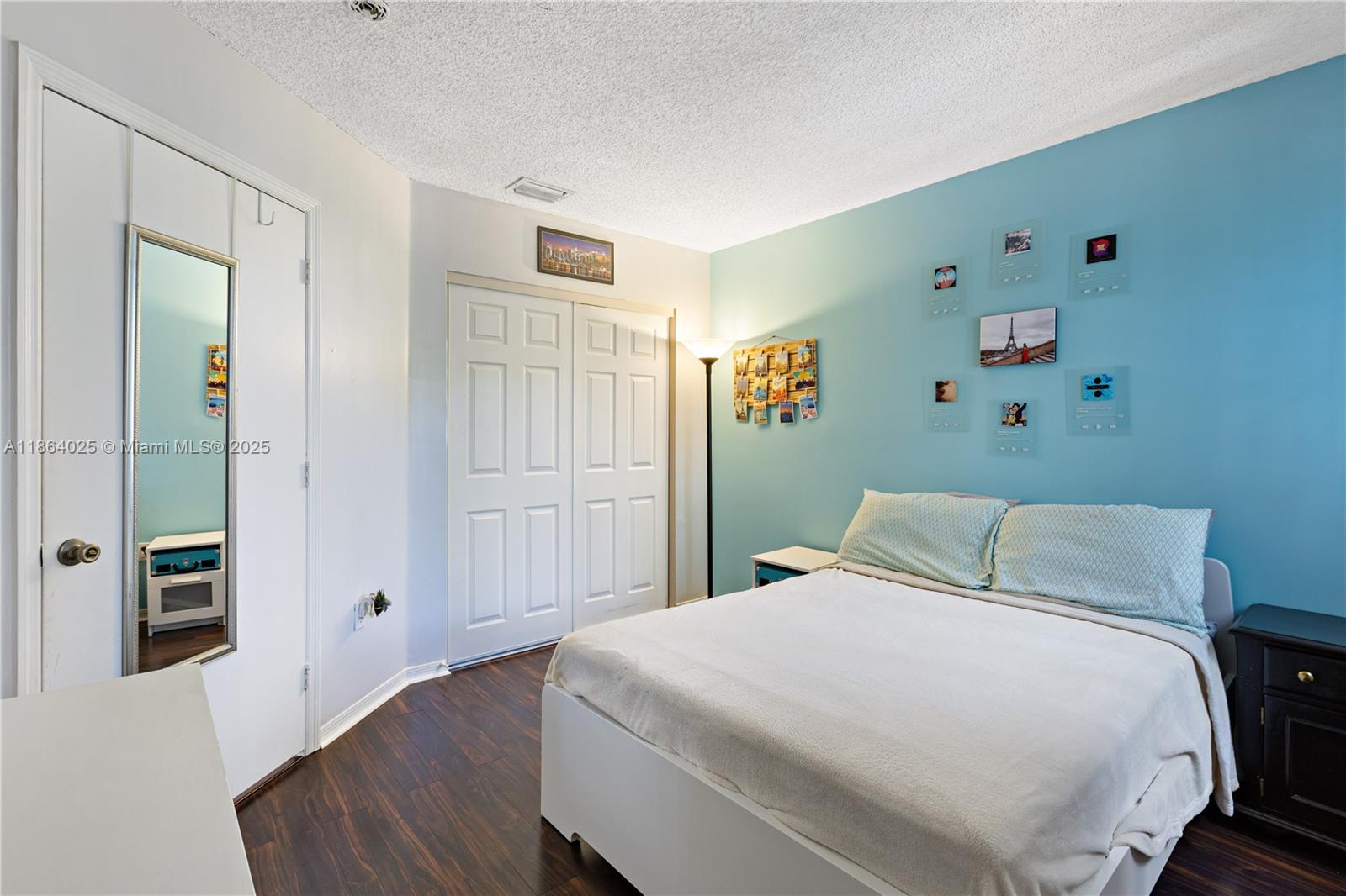 13402 Southwest 153rd Street, Unit 1905 Miami, FL 33177 - Photo 13 of 21 a bedroom with a bed and wooden floor