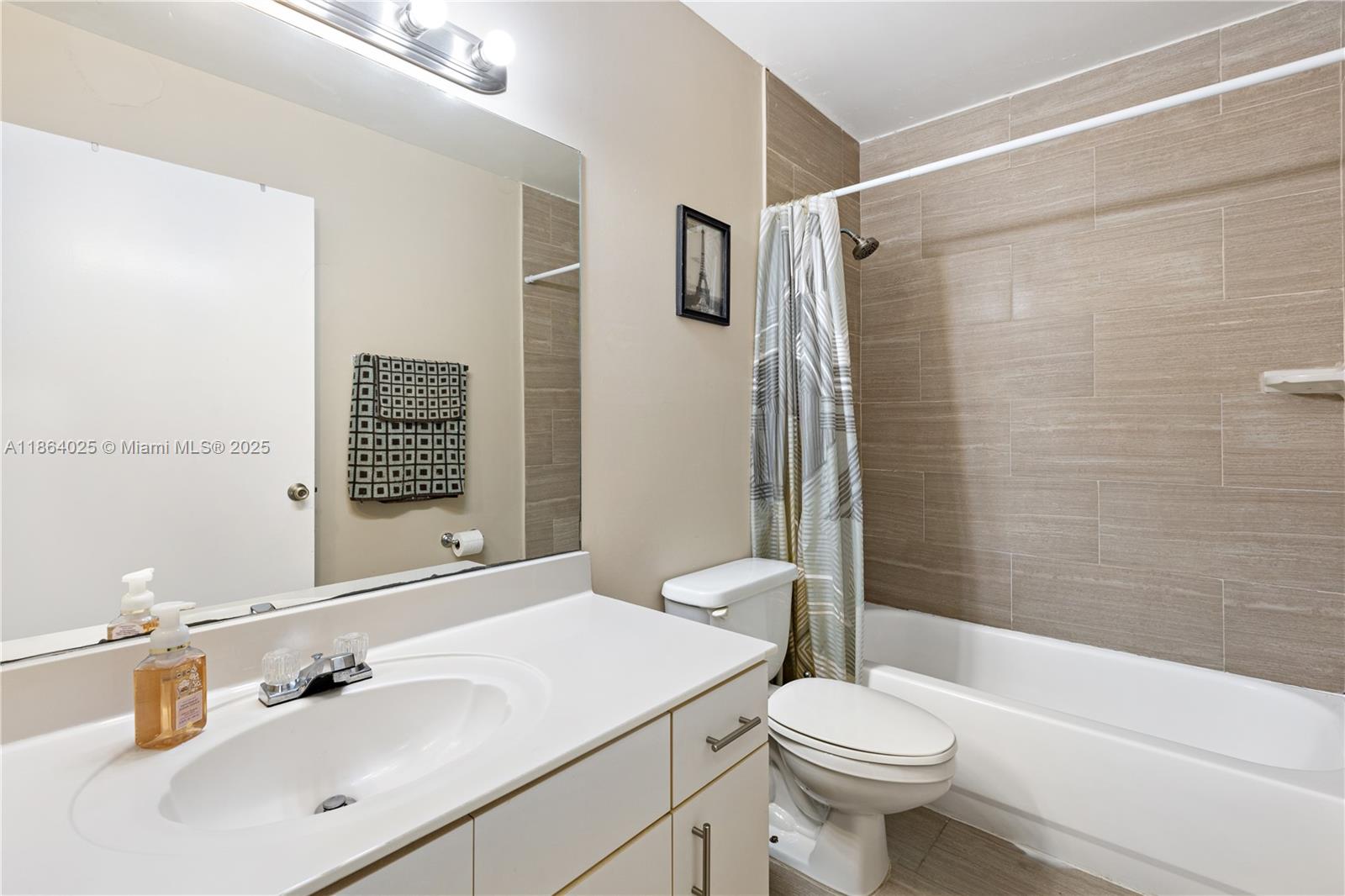 13402 Southwest 153rd Street, Unit 1905 Miami, FL 33177 - Photo 15 of 21 a bathroom with a sink toilet and shower