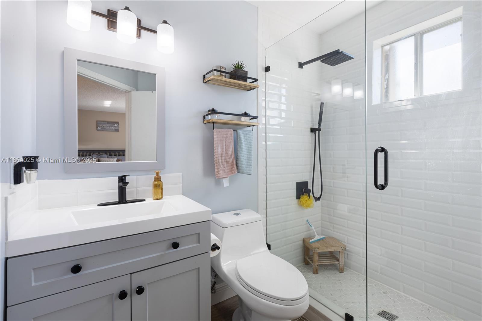 13402 Southwest 153rd Street, Unit 1905 Miami, FL 33177 - Photo 18 of 21 a bathroom with a sink a toilet and shower