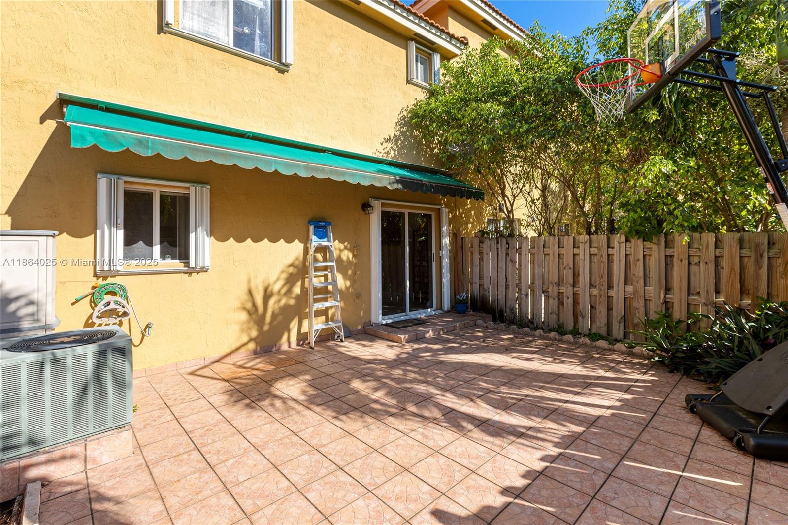 13402 Southwest 153rd Street, Unit 1905 Miami, FL 33177 - Photo 20 of 21 a backyard of a house with seating space