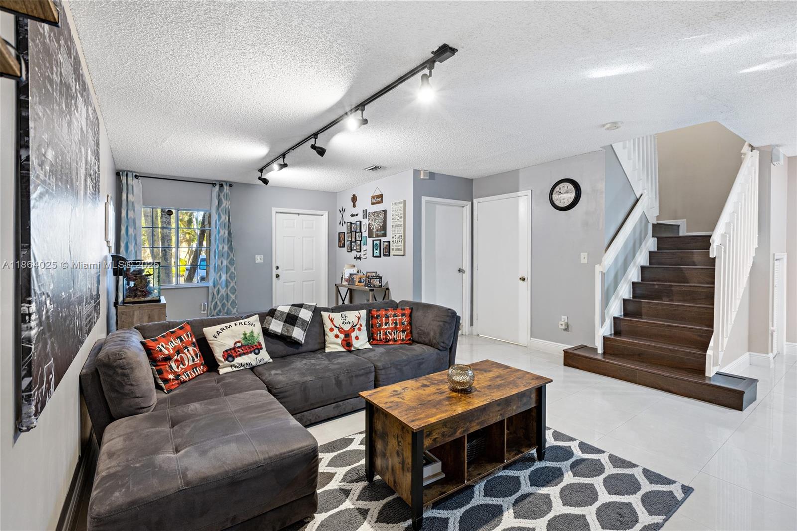 13402 Southwest 153rd Street, Unit 1905 Miami, FL 33177 - Photo 3 of 21 a living room with furniture and a painting