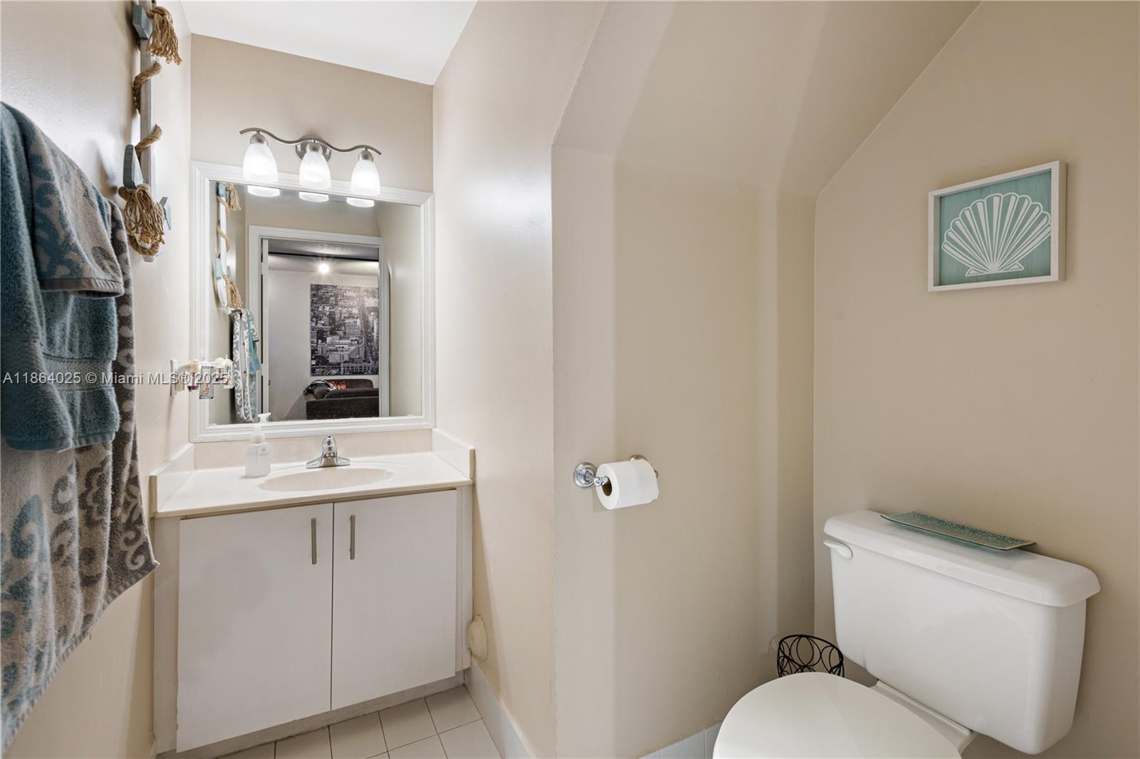 13402 Southwest 153rd Street, Unit 1905 Miami, FL 33177 - Photo 8 of 21 a bathroom with a toilet sink and mirror