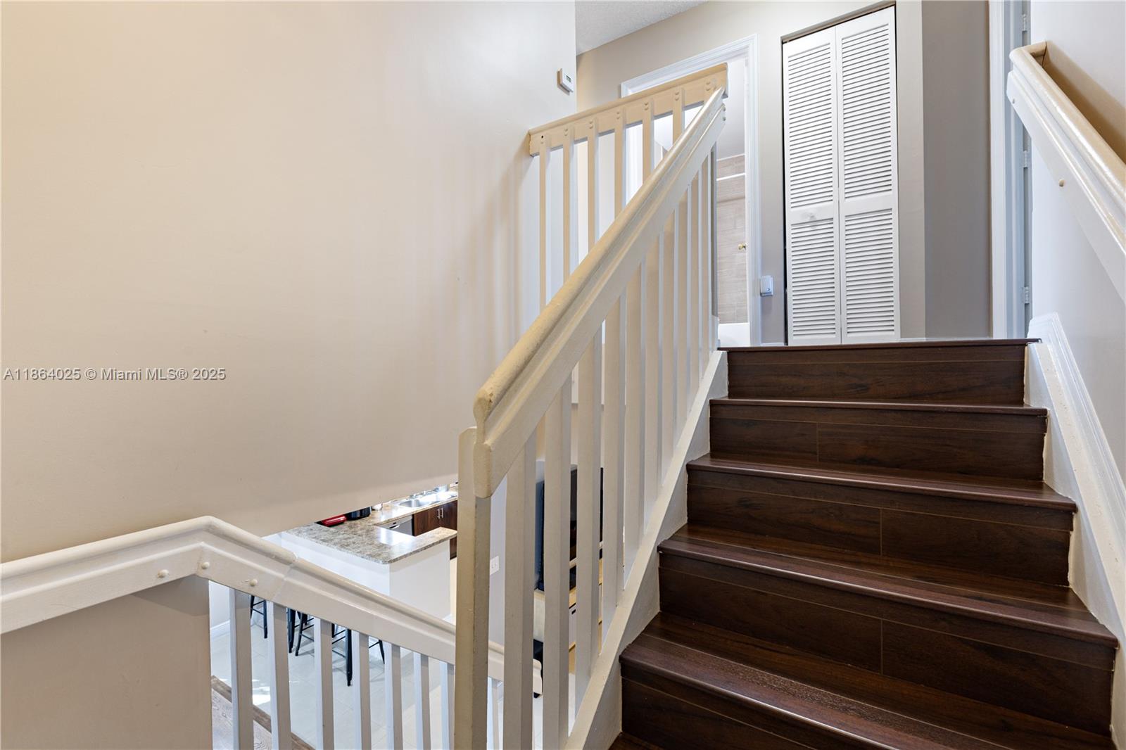 13402 Southwest 153rd Street, Unit 1905 Miami, FL 33177 - Photo 9 of 21 a view of staircase with wooden floor and white walls