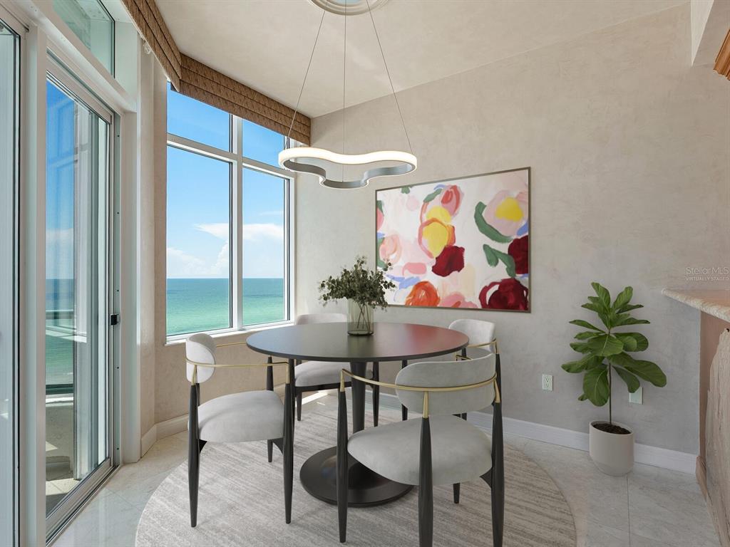 655 Longboat Club Road, Unit 16B Longboat Key, FL 34228 - Photo 11 of 50 a view of a dining room with furniture one side kitchen view and a chandelier