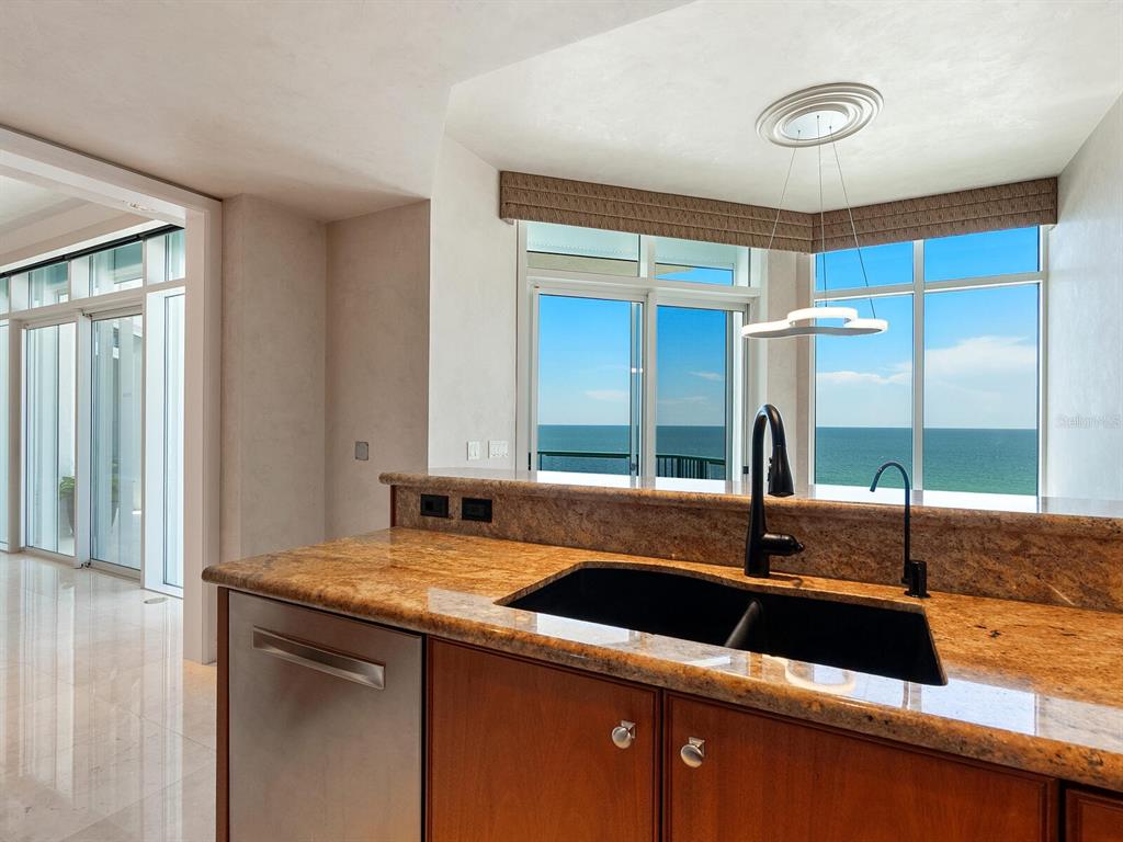 655 Longboat Club Road, Unit 16B Longboat Key, FL 34228 - Photo 13 of 50 a kitchen with a sink and a wooden floor