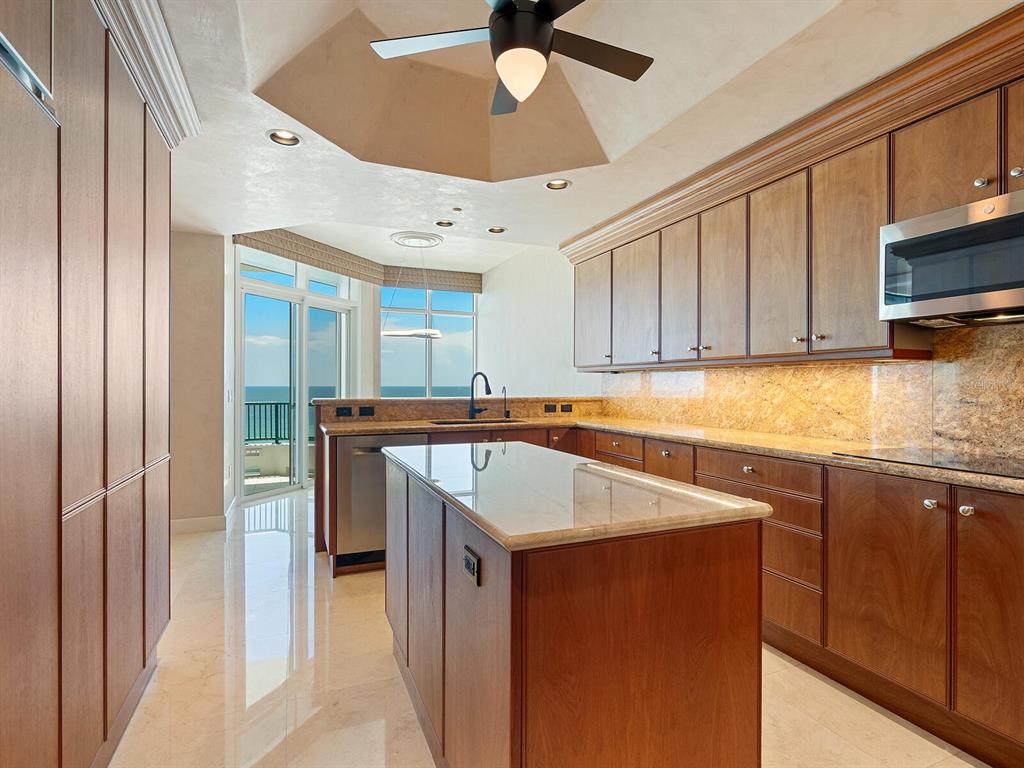 655 Longboat Club Road, Unit 16B Longboat Key, FL 34228 - Photo 15 of 50 a kitchen with stainless steel appliances granite countertop a sink and cabinets