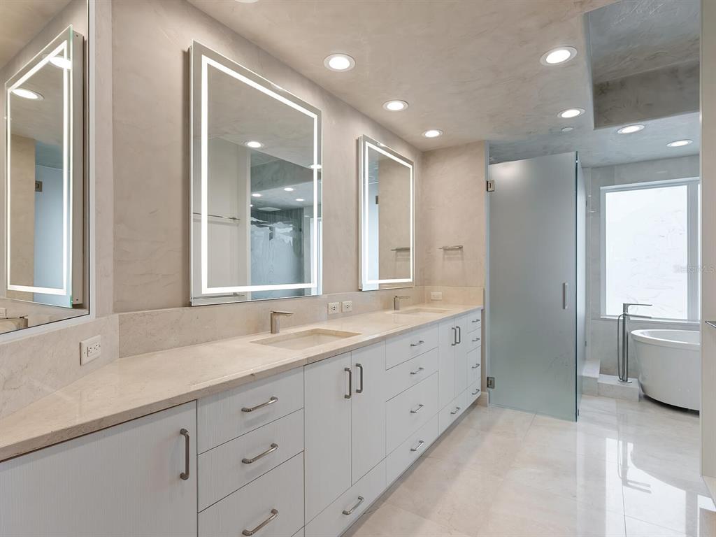 655 Longboat Club Road, Unit 16B Longboat Key, FL 34228 - Photo 21 of 50 a bathroom with double sink and a large mirror